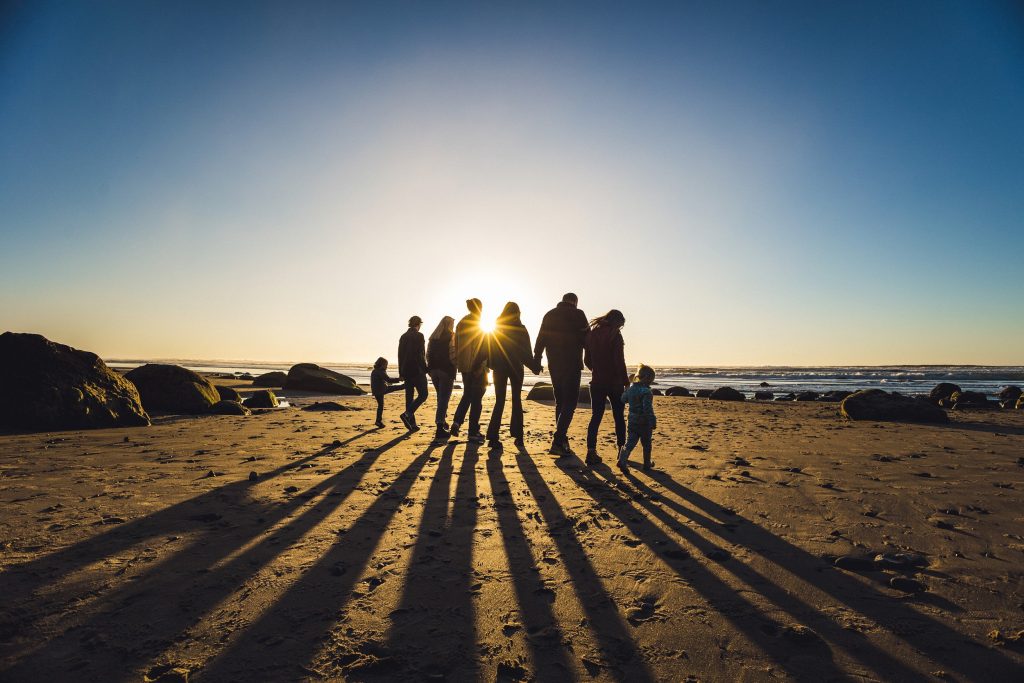 A large family walking on the beach in Lincoln City for extended family portraits